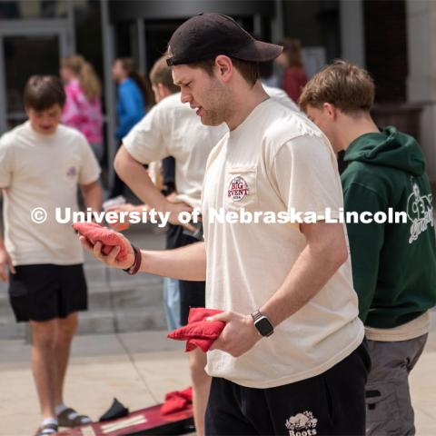Max Booher, a member of Pi Kappa Alpha, prepares to throw his bag in a game of corn hole before the start of the Big Event. May 4, 2024. Photo by Kirk Rangel for University Communication.